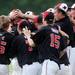 Milan High School baseball players mob their pitcher sophomore Thomas Lindeman as they celebrate beating Coldwater, 1-0, during the MHSAA baseball quarterfinals at Nichols Field at Bailey Park in Battle Creek on Tuesday, June 11, 2013. Melanie Maxwell | AnnArbor.com